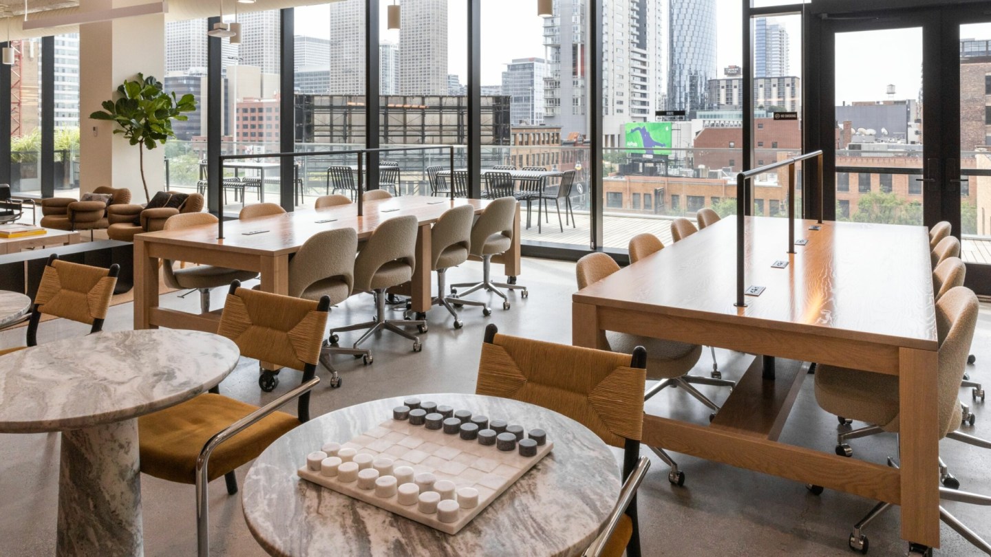 Workspaces by floor-to-ceiling windows.