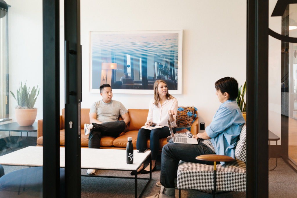 3 Colleagues Engaging in a Meeting Room at a WeWork Location
