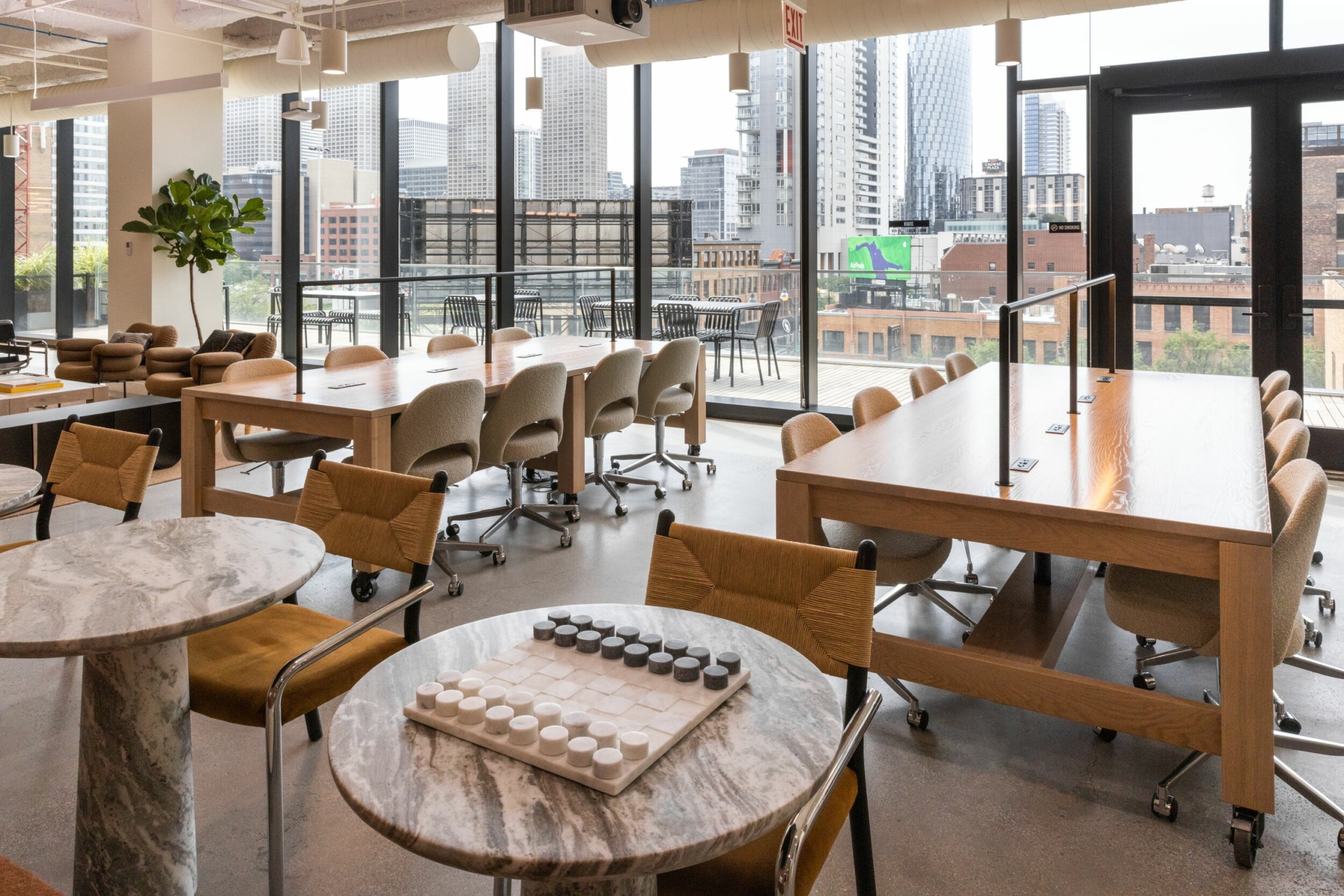 Workspaces by floor-to-ceiling windows.