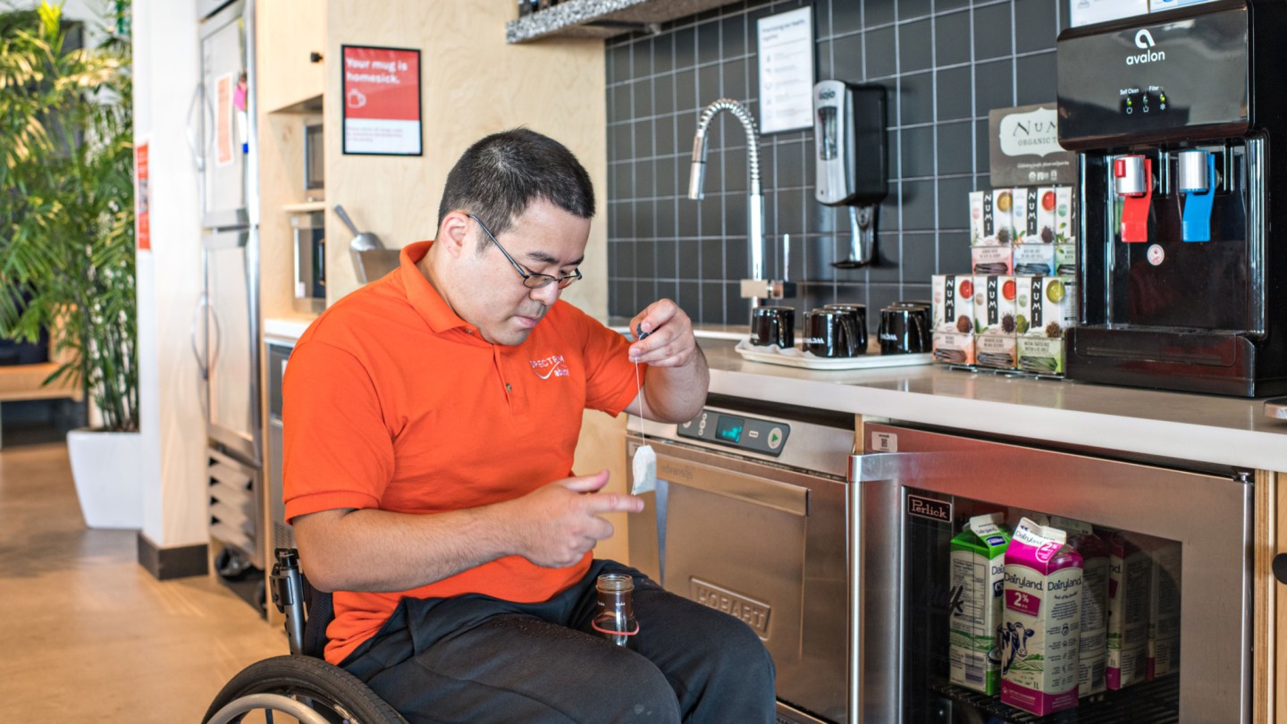 An accessibility expert in the kitchen at WeWork.