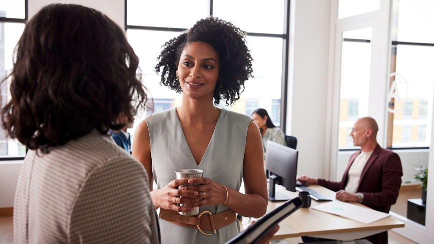 Two women chatting in an office