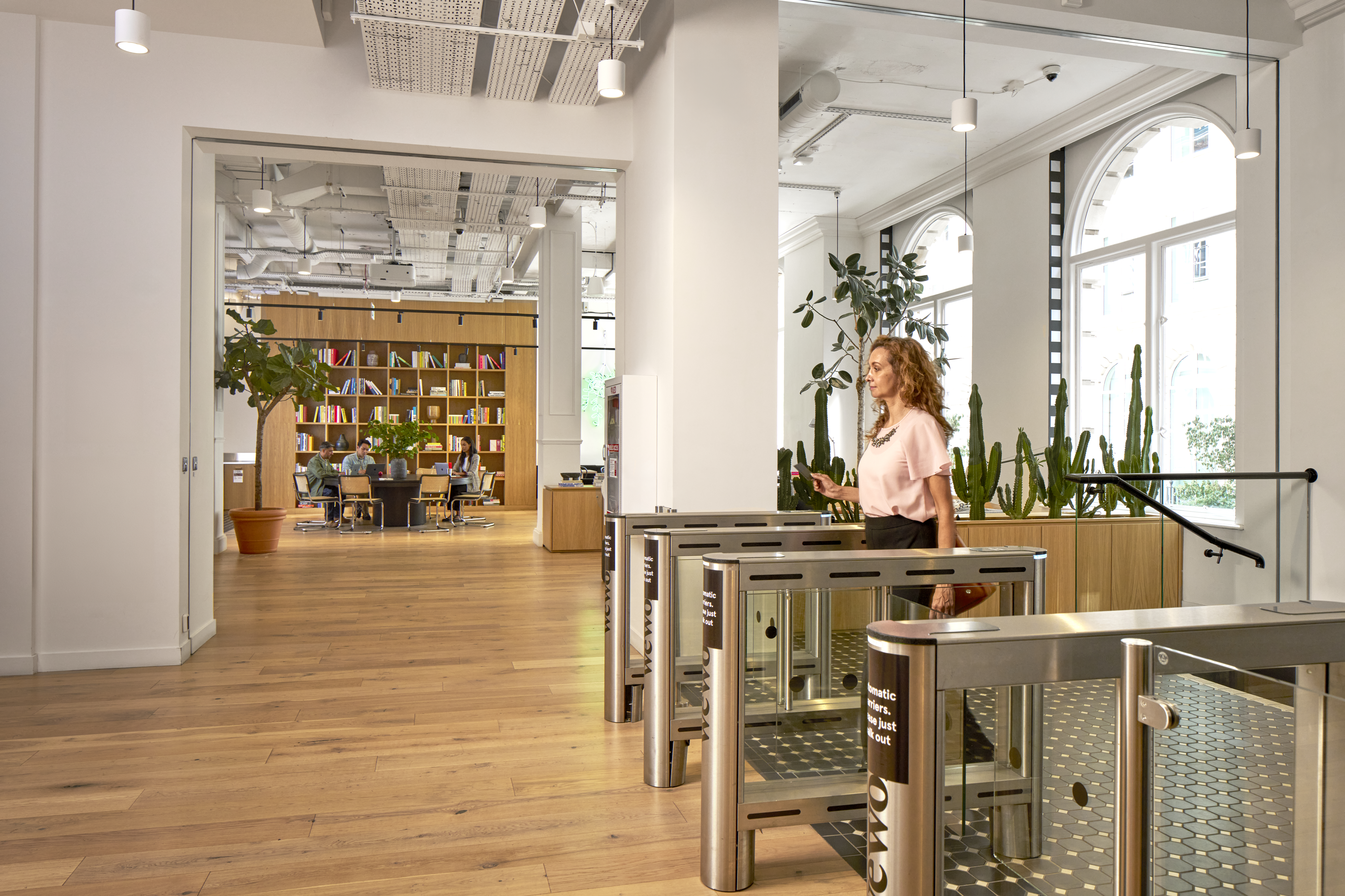 Woman entering a WeWork space with access card