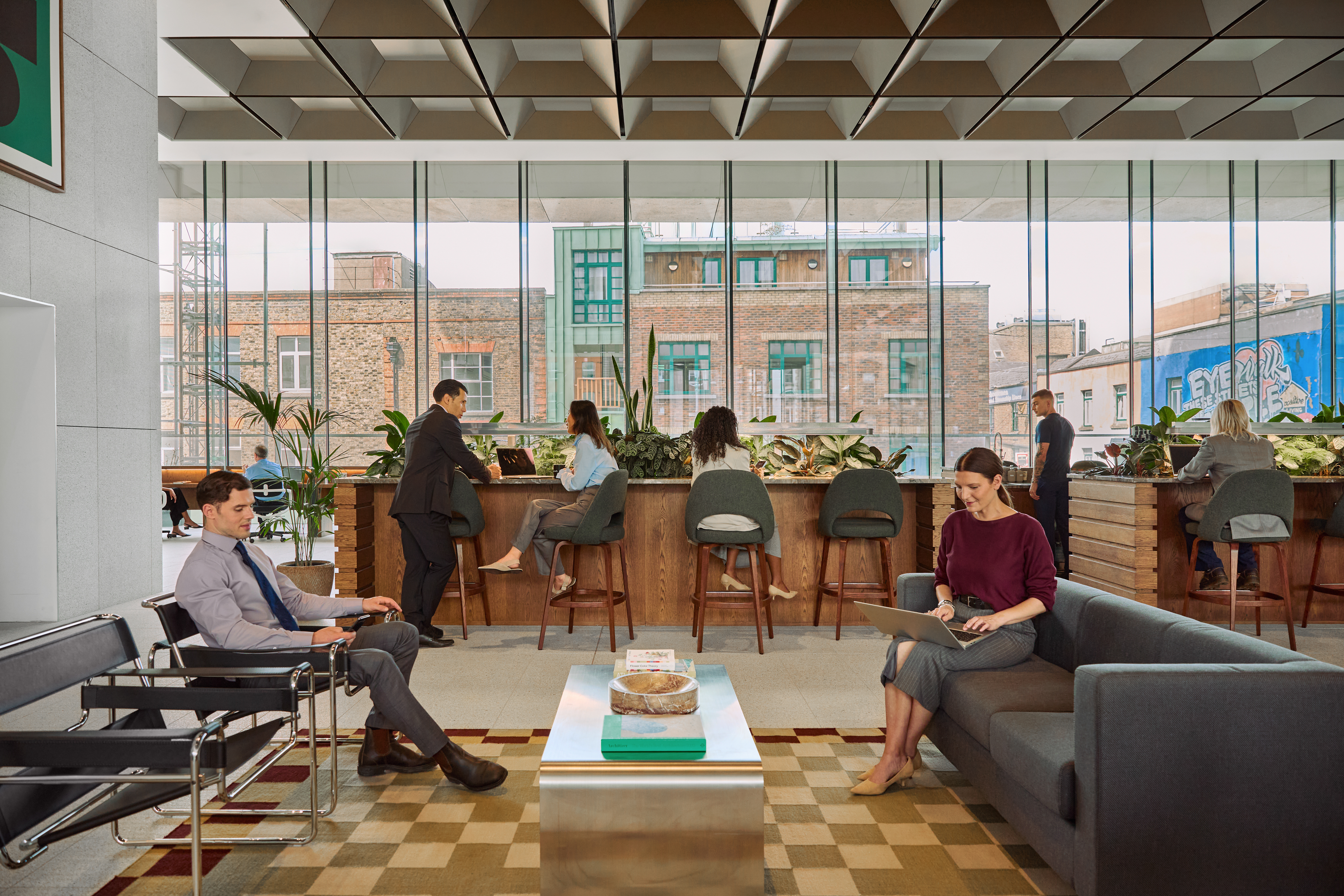 people working and socializing in a WeWork shared space