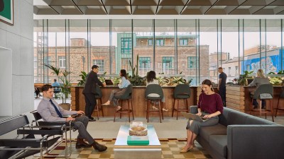 people working and socializing in a WeWork shared space