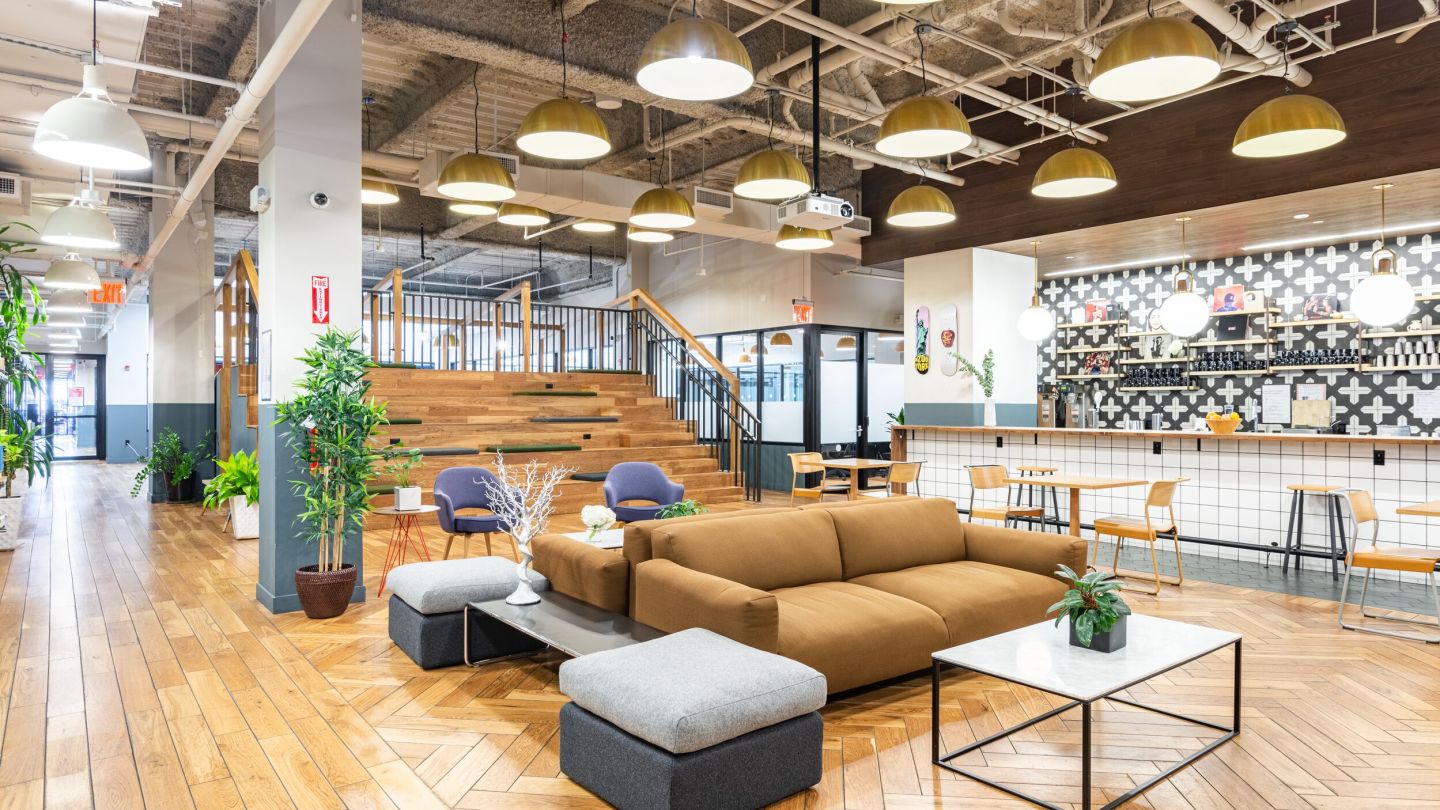 well-lit and colorful lounge and kitchen in a WeWork building