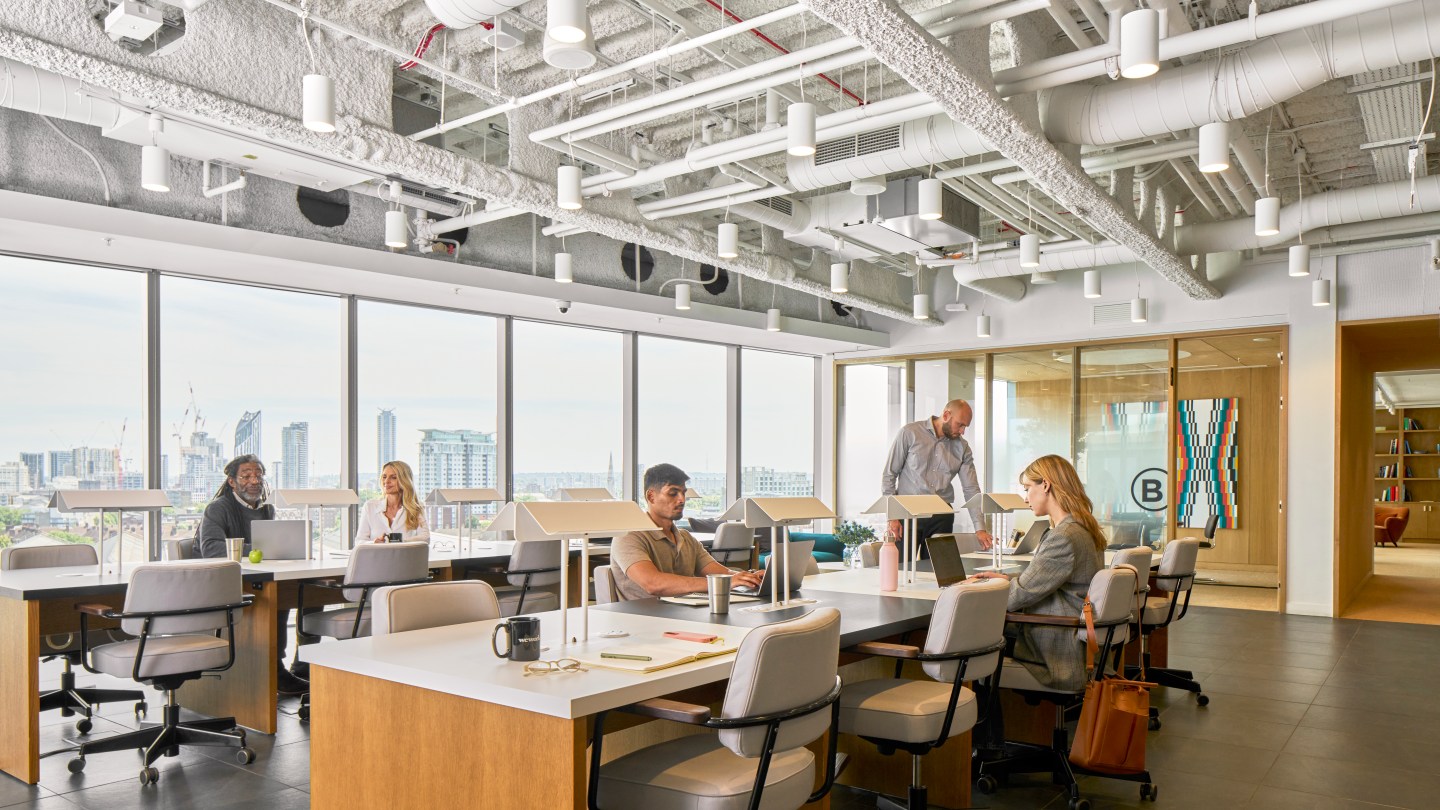 people working in an open, shared WeWork space