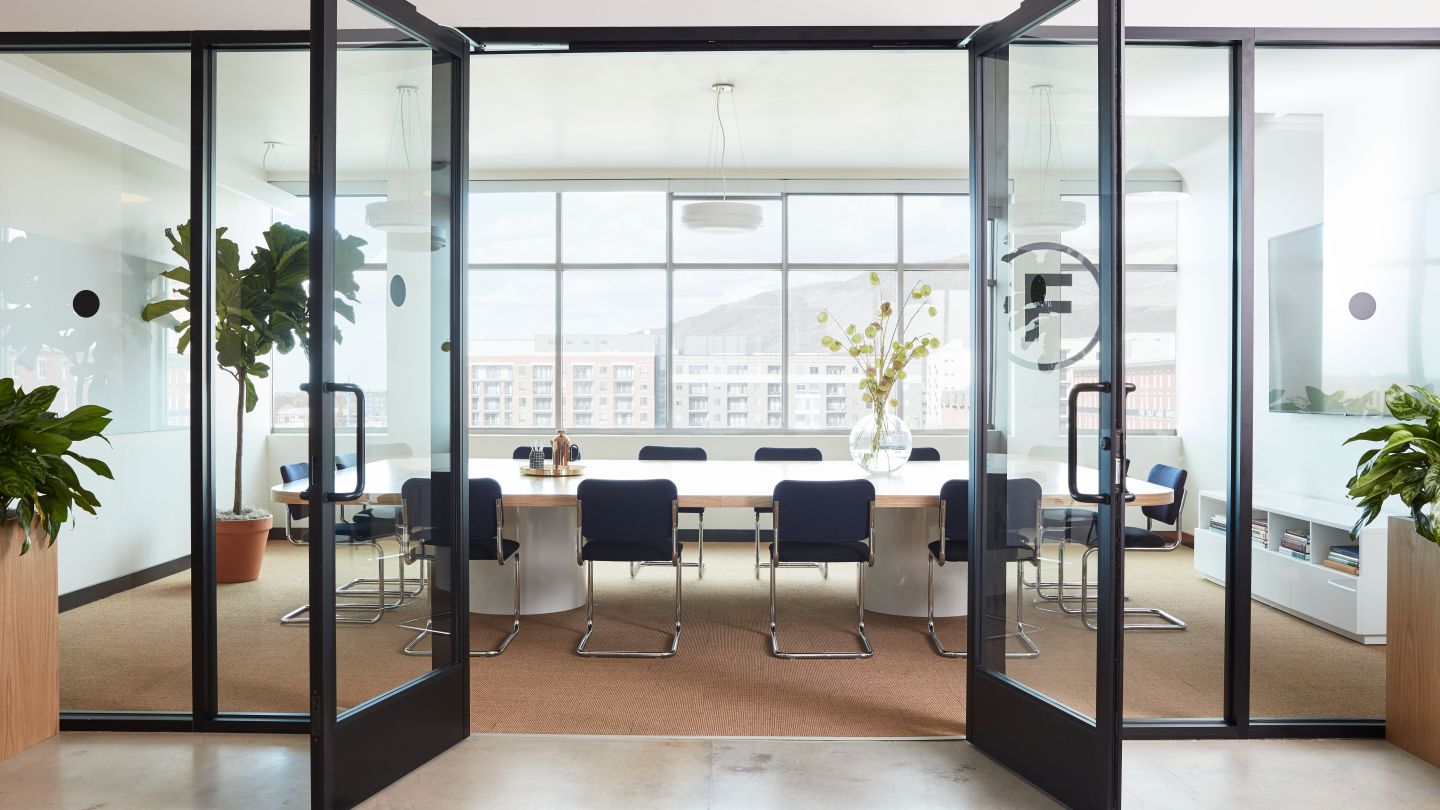 bright WeWork conference room with doors open