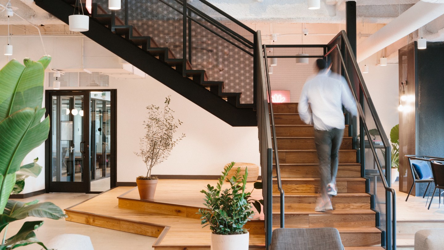 WeWork member walking up the stairs in the Pacific Design Center, LA