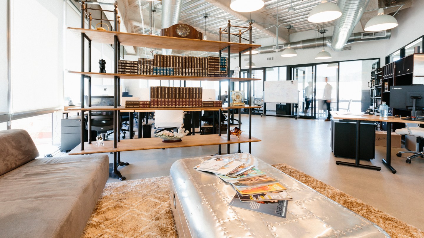 inside WeWork Pacific Design Center, view of comfortable seating area and meeting room with glass walls