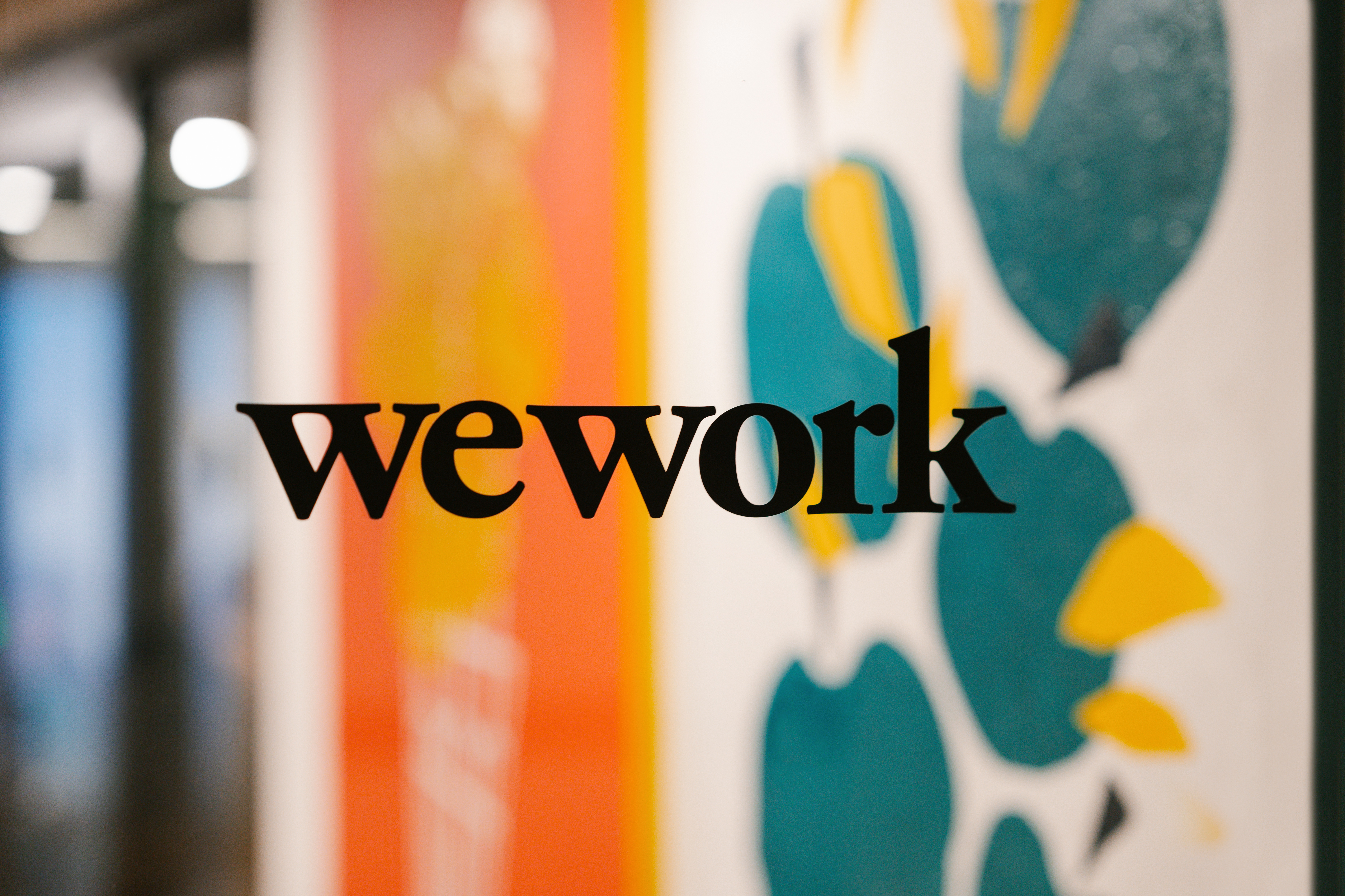 WeWork brand logo on a glass door/window