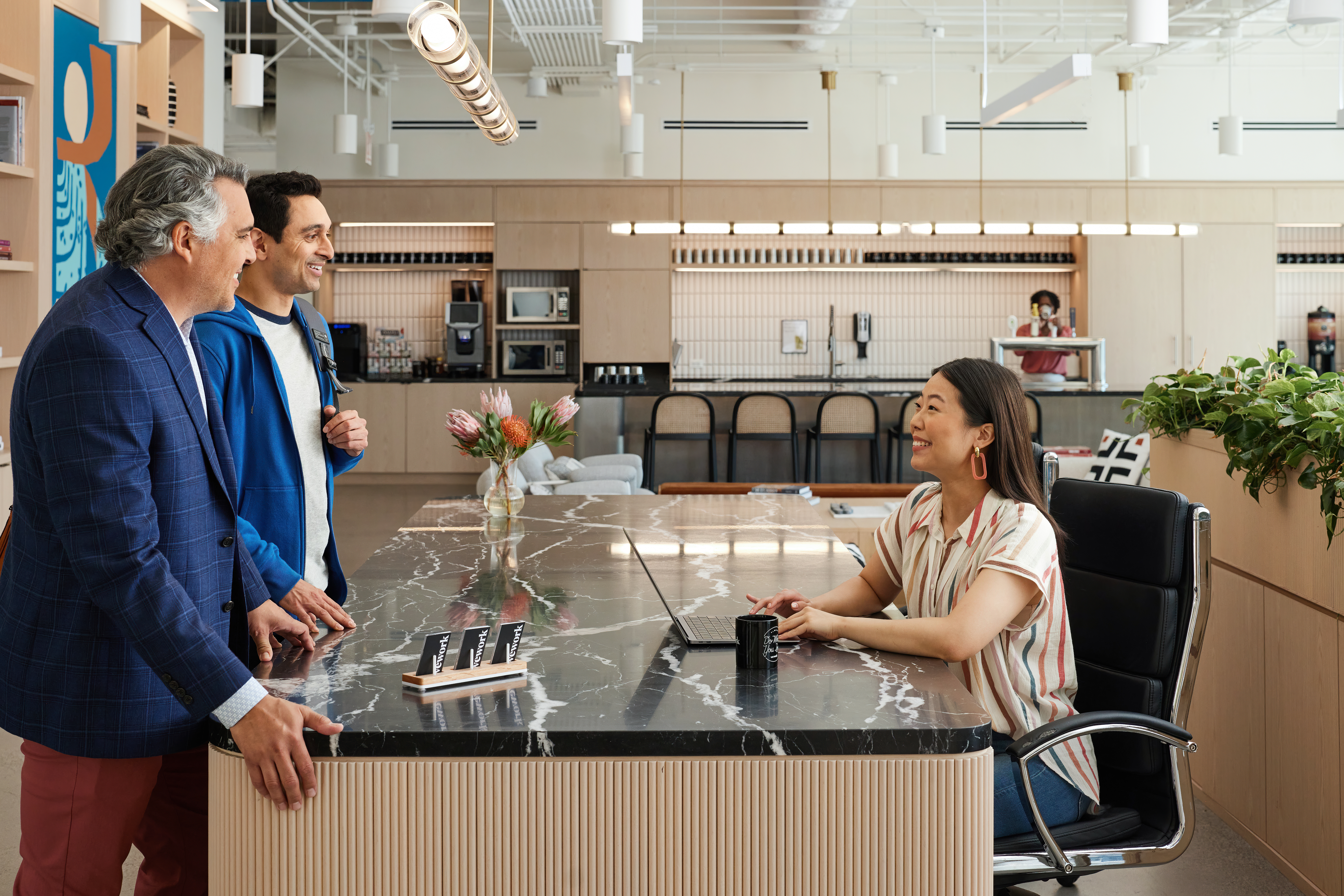 WeWork members receiving their keycards at reception on arrival