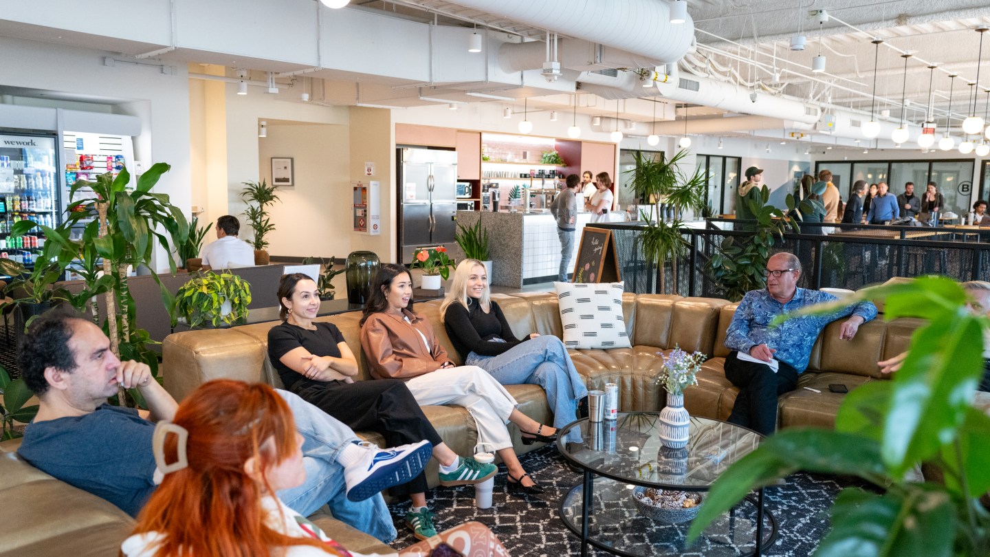 WeWork members talking, socializing, collaborating inside Pacific Design Center in LA