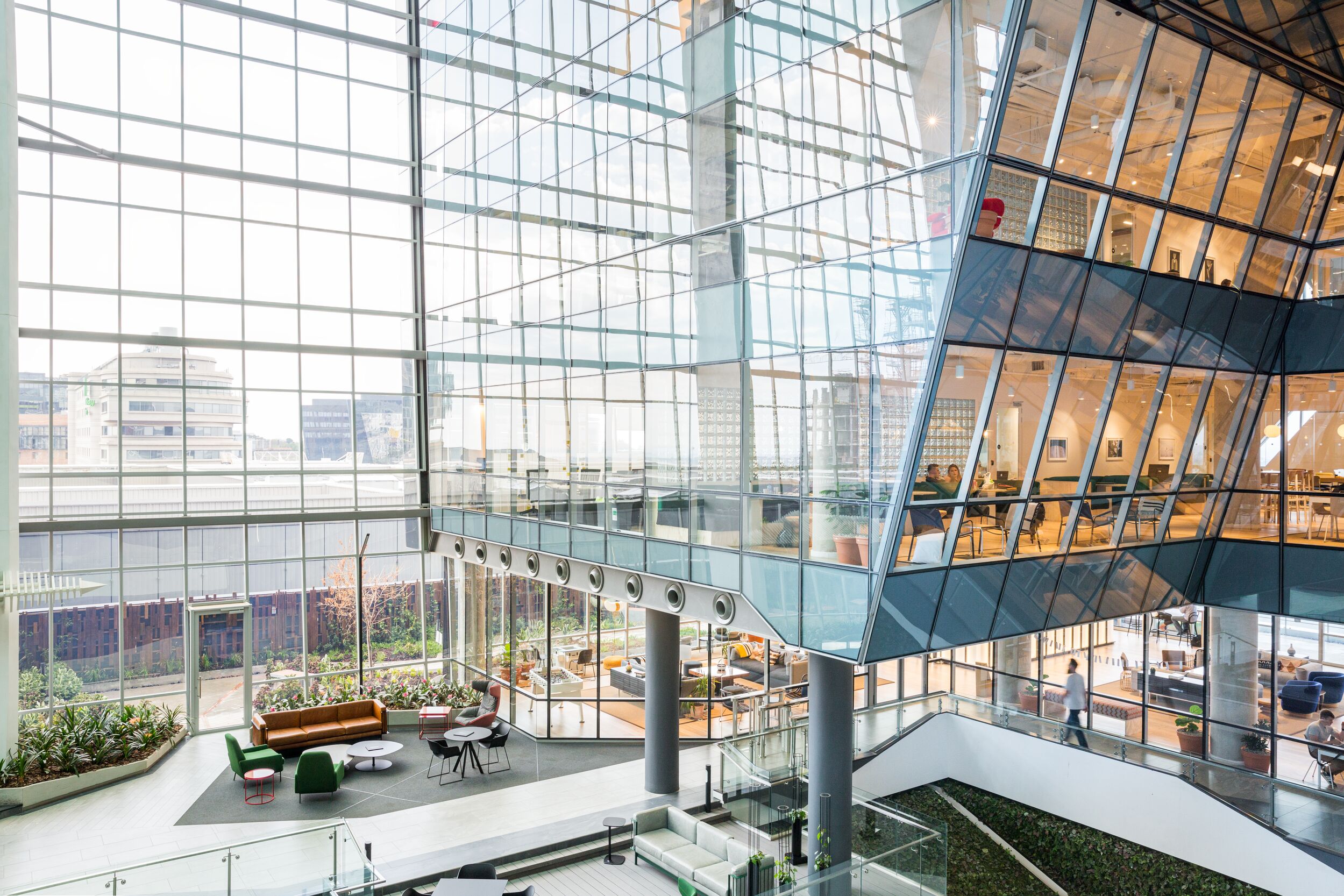 Office building with floor-to-ceiling windows, seen from outside.