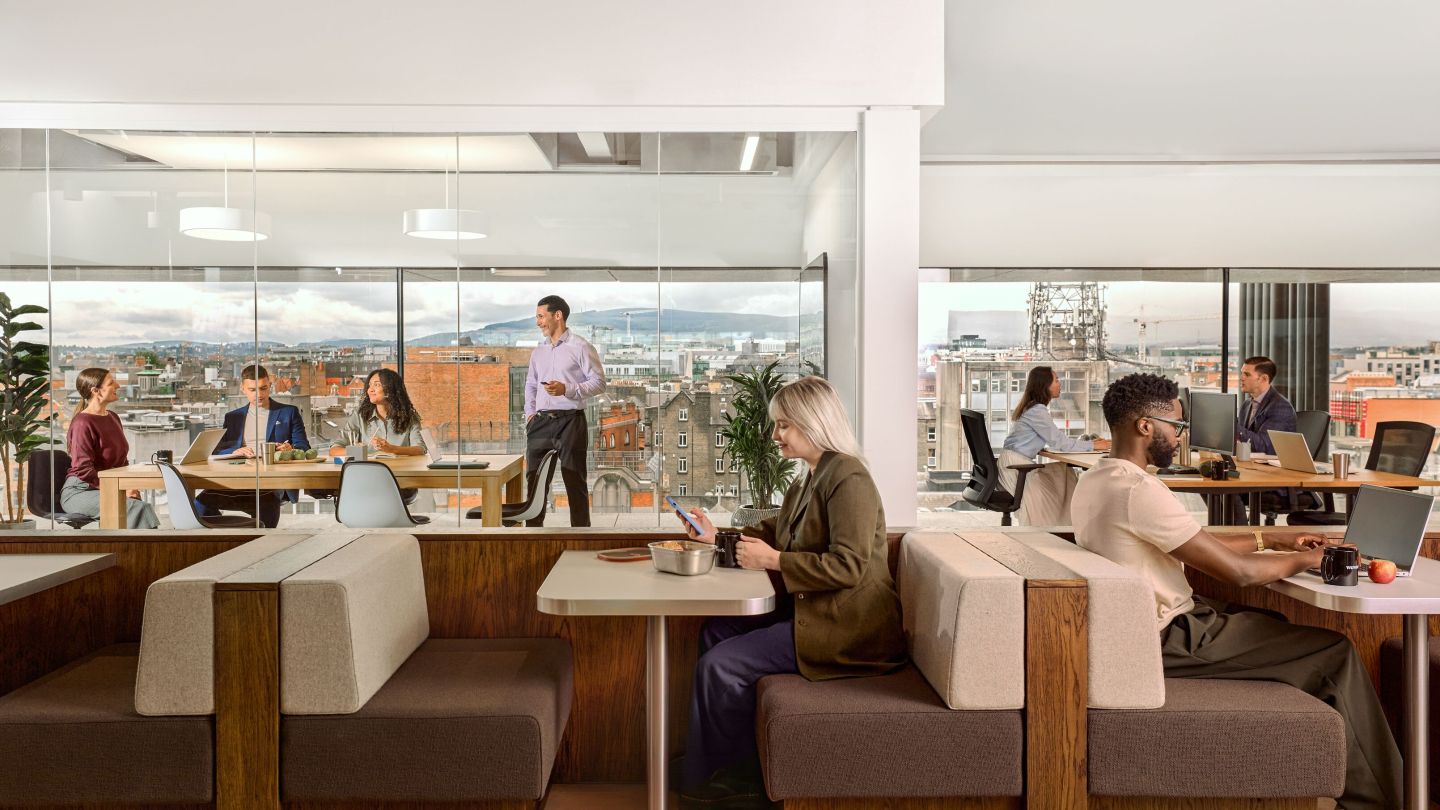People working from various seats in a coworking space. 