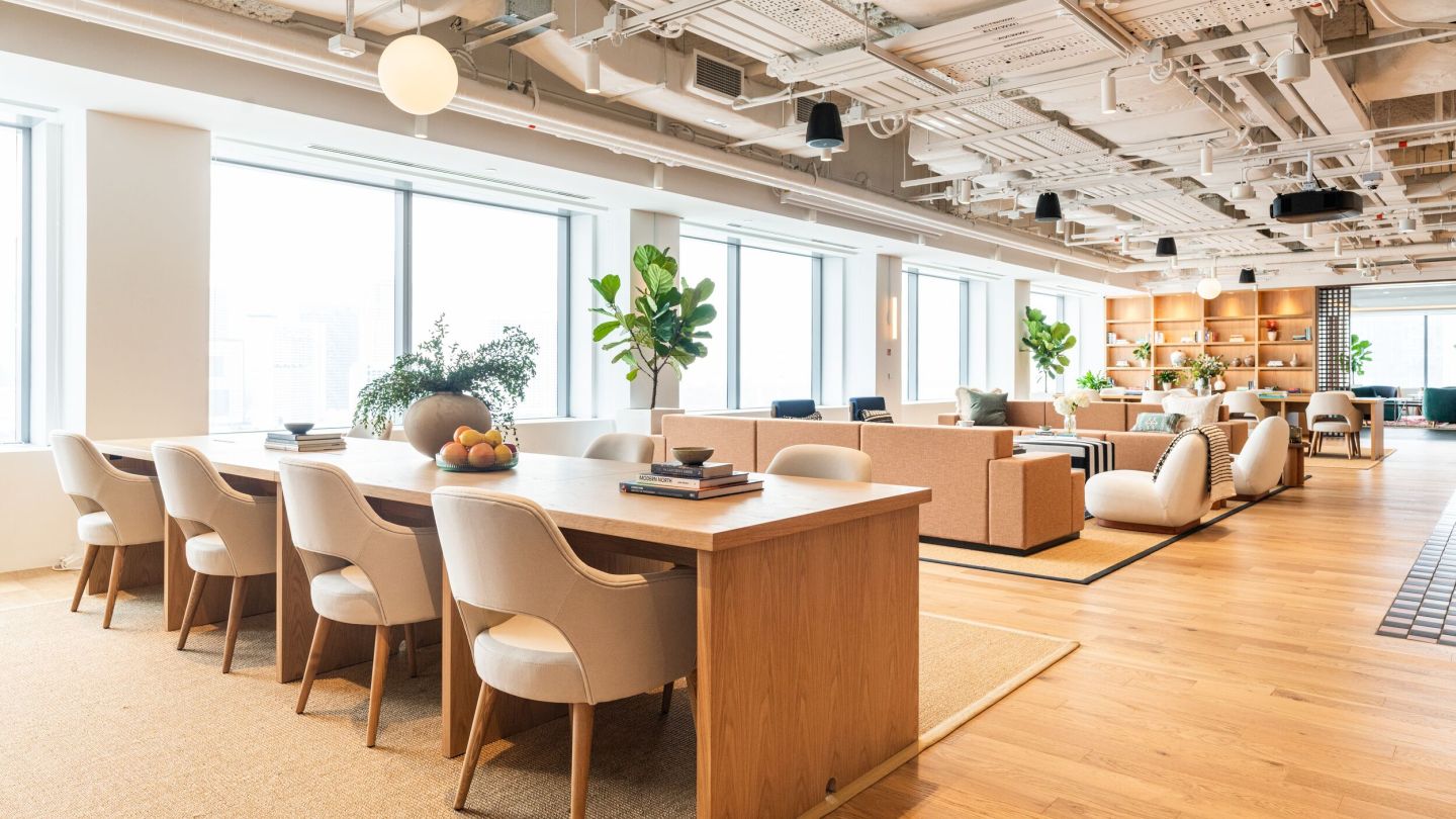 An empty, bright, nicely-decorated coworking space, showing various seating areas.