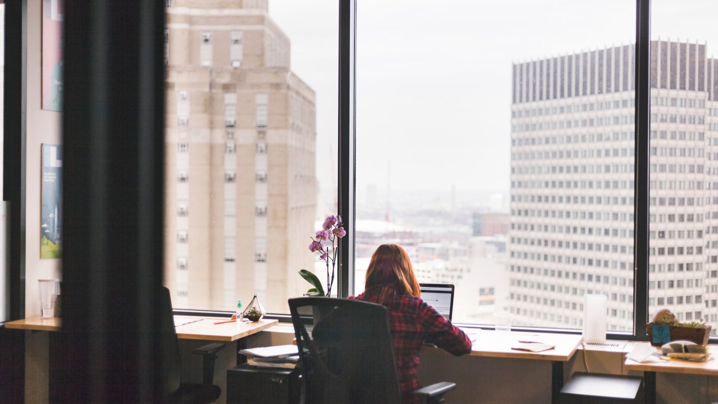 member enjoying a WeWork office with city views