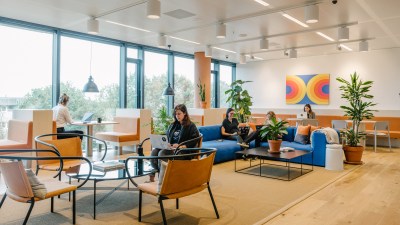 people working in different areas of a coworking space