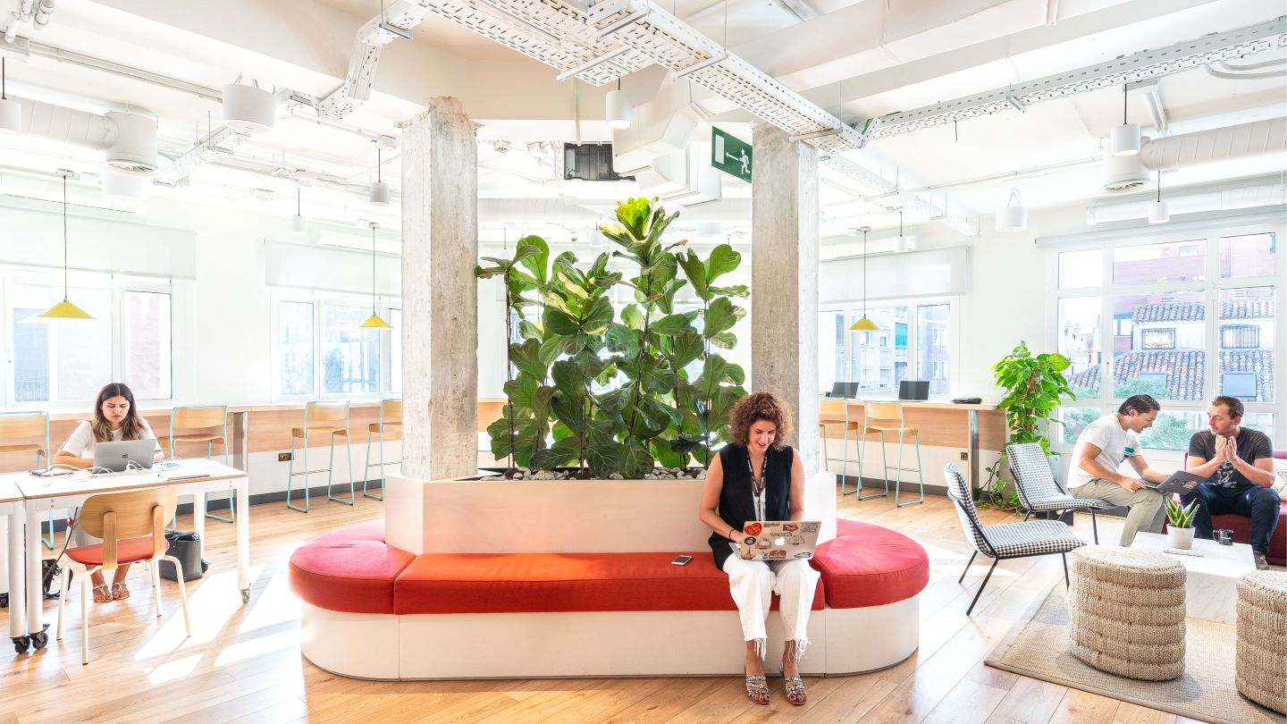 people working individually and in groups in a WeWork coworking space