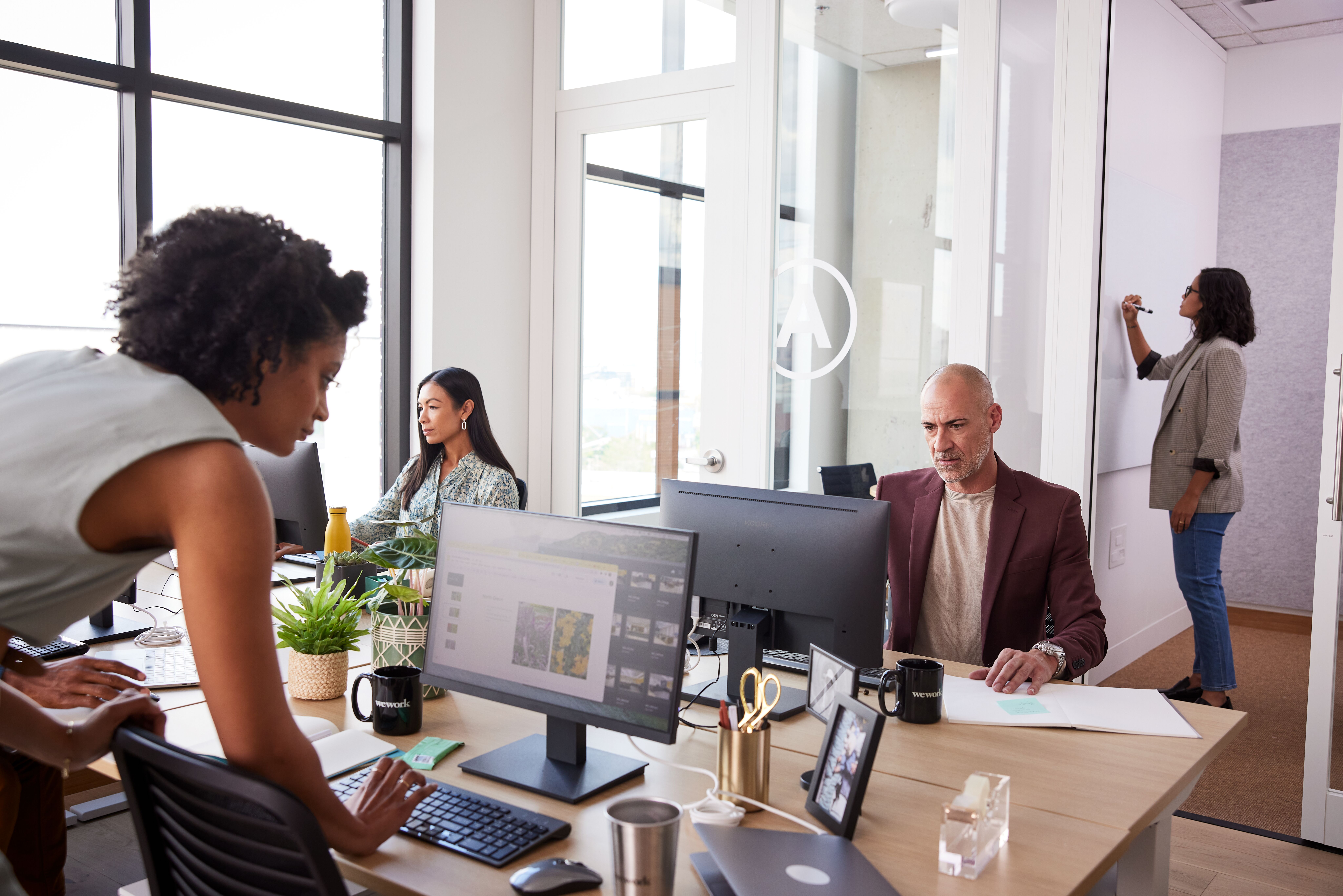 small team working in a WeWork meeting room
