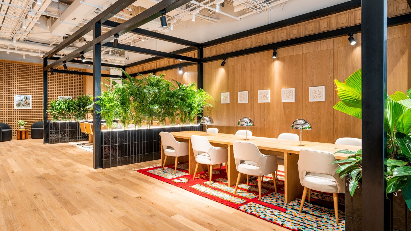 modern shared workspace with plants, inviting decor and lighting