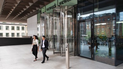 two smartly dressed people leaving a WeWork building