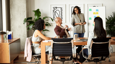 People sitting around the table for a meeting.