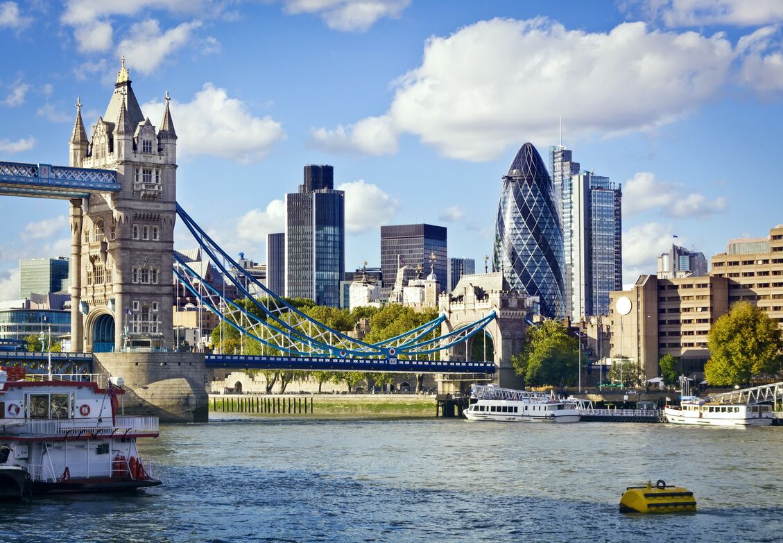 Water scenery showing the London bridge, tall buildings in the background.